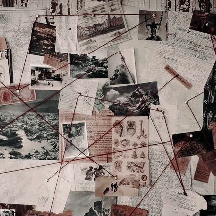 photos and articles pinned to a board with strings connecting them